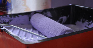 This image shows a roller brush with paint.
