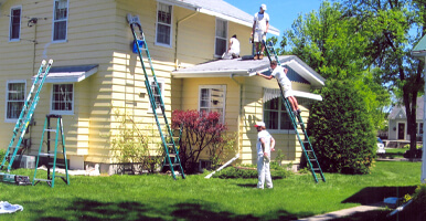 This image shows men painting a house.