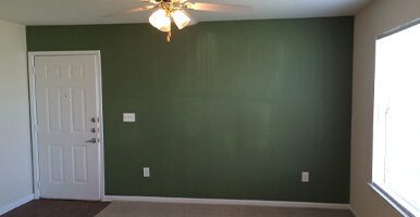 This image shows a living room. The wall is newly painted.