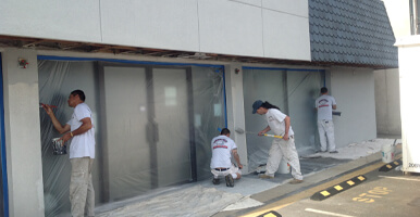 This image shows men painting a commercial space.