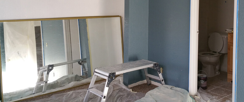 This image shows a living room that is being painted.
